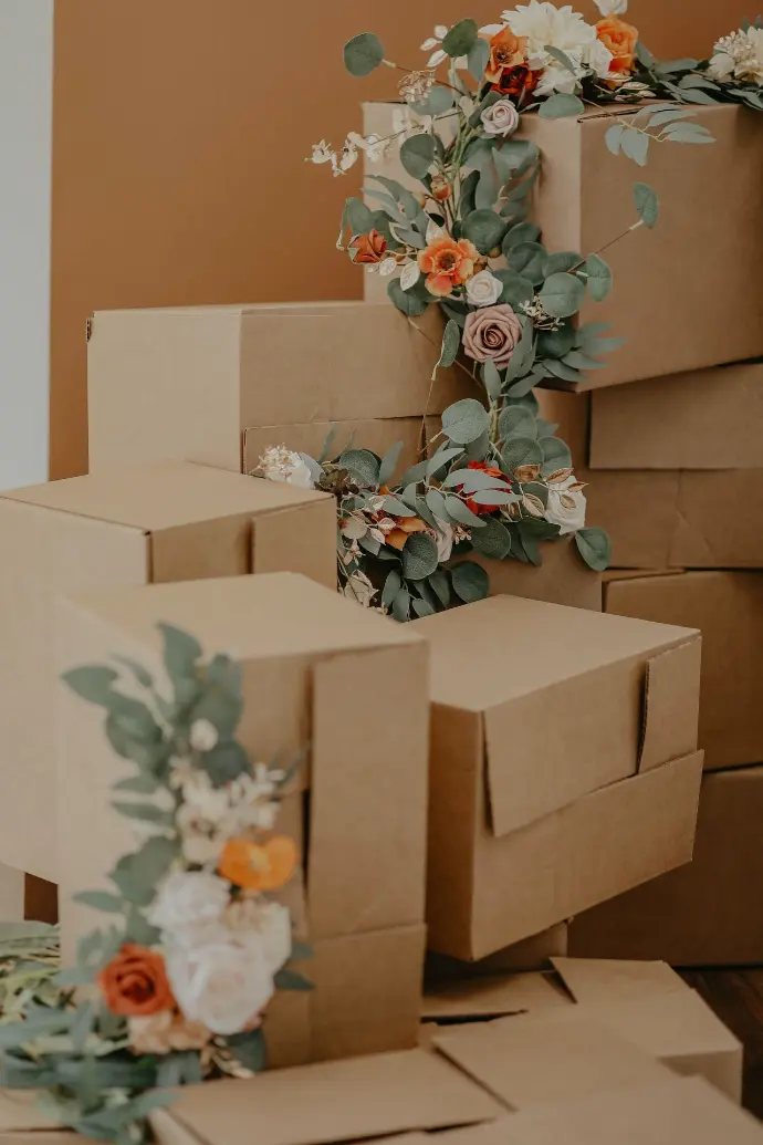 brown cardboard box with green and red flowers